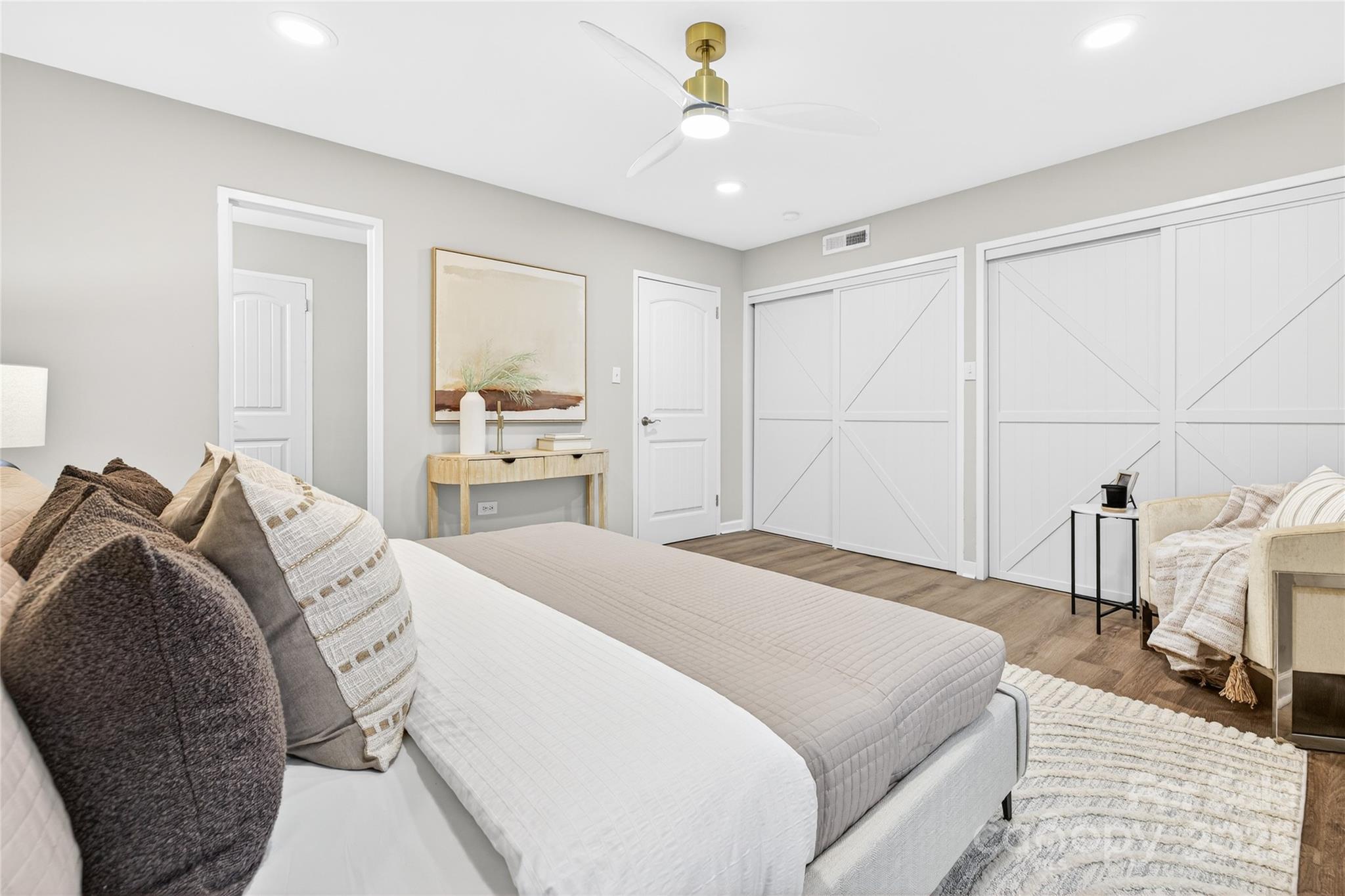 1300 Queens Road, Unit 409 Charlotte, NC 28207 - Photo 17 of 35 a bedroom with a bed and a chandelier