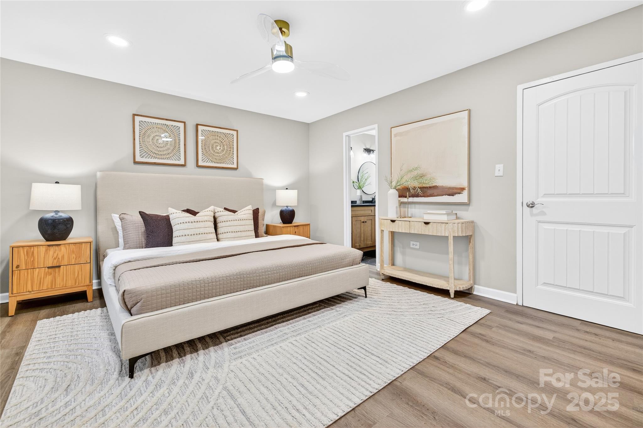1300 Queens Road, Unit 409 Charlotte, NC 28207 - Photo 19 of 35 a spacious bedroom with a bed and wooden floor