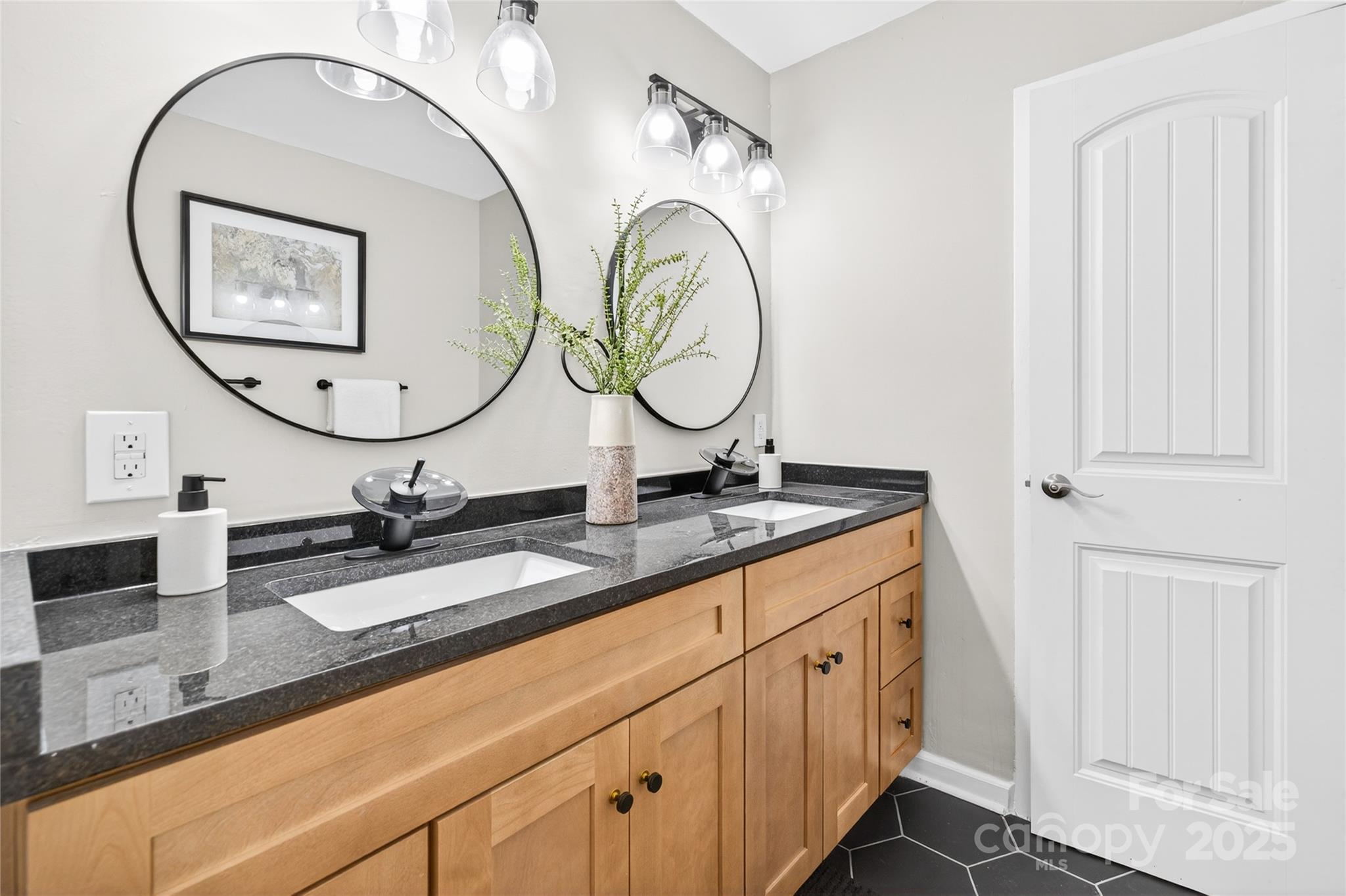 1300 Queens Road, Unit 409 Charlotte, NC 28207 - Photo 20 of 35 a bathroom with a granite countertop double vanity sinks and a mirror