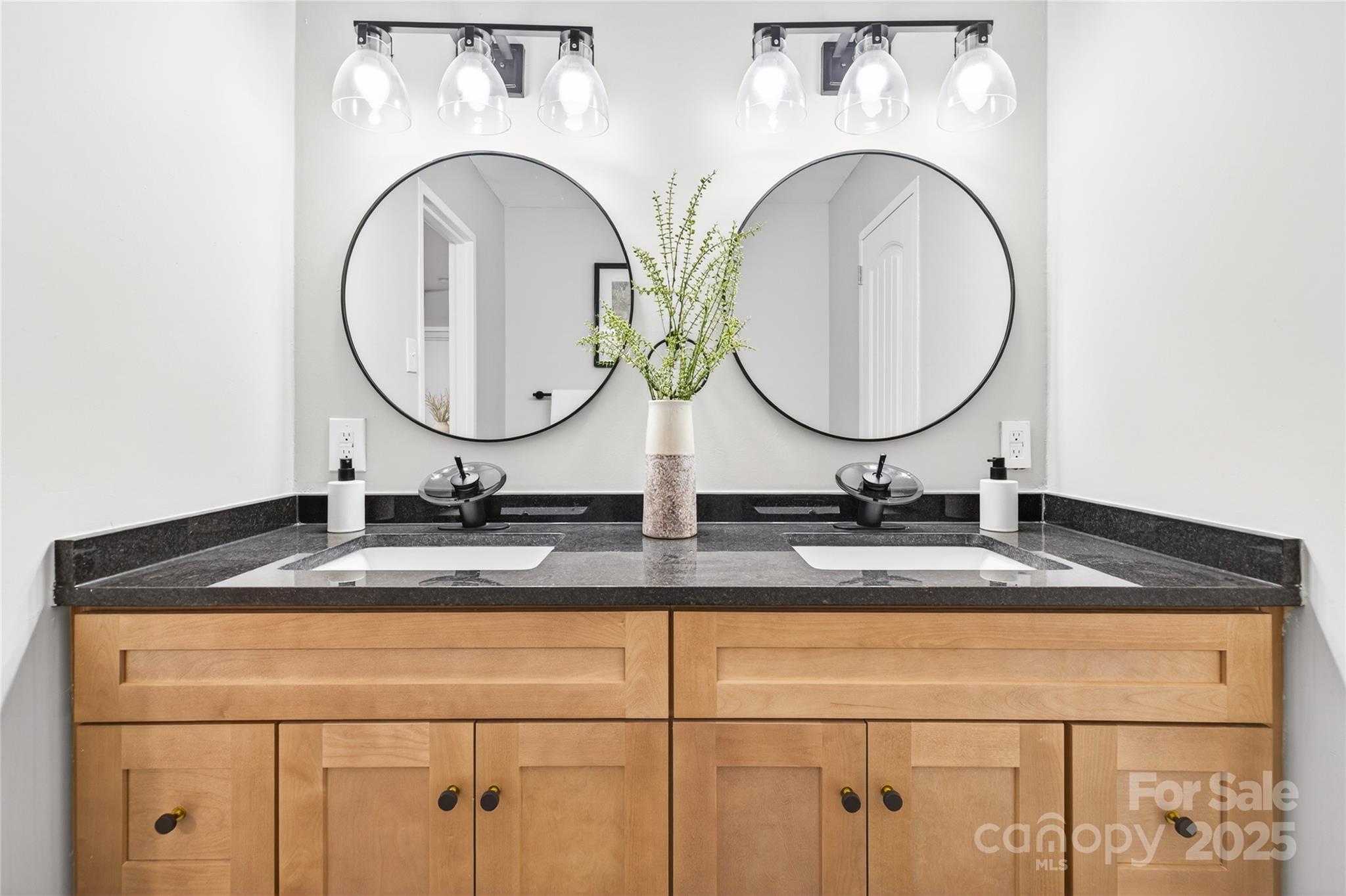 1300 Queens Road, Unit 409 Charlotte, NC 28207 - Photo 21 of 35 a bathroom with a granite countertop double vanity sink and a mirror