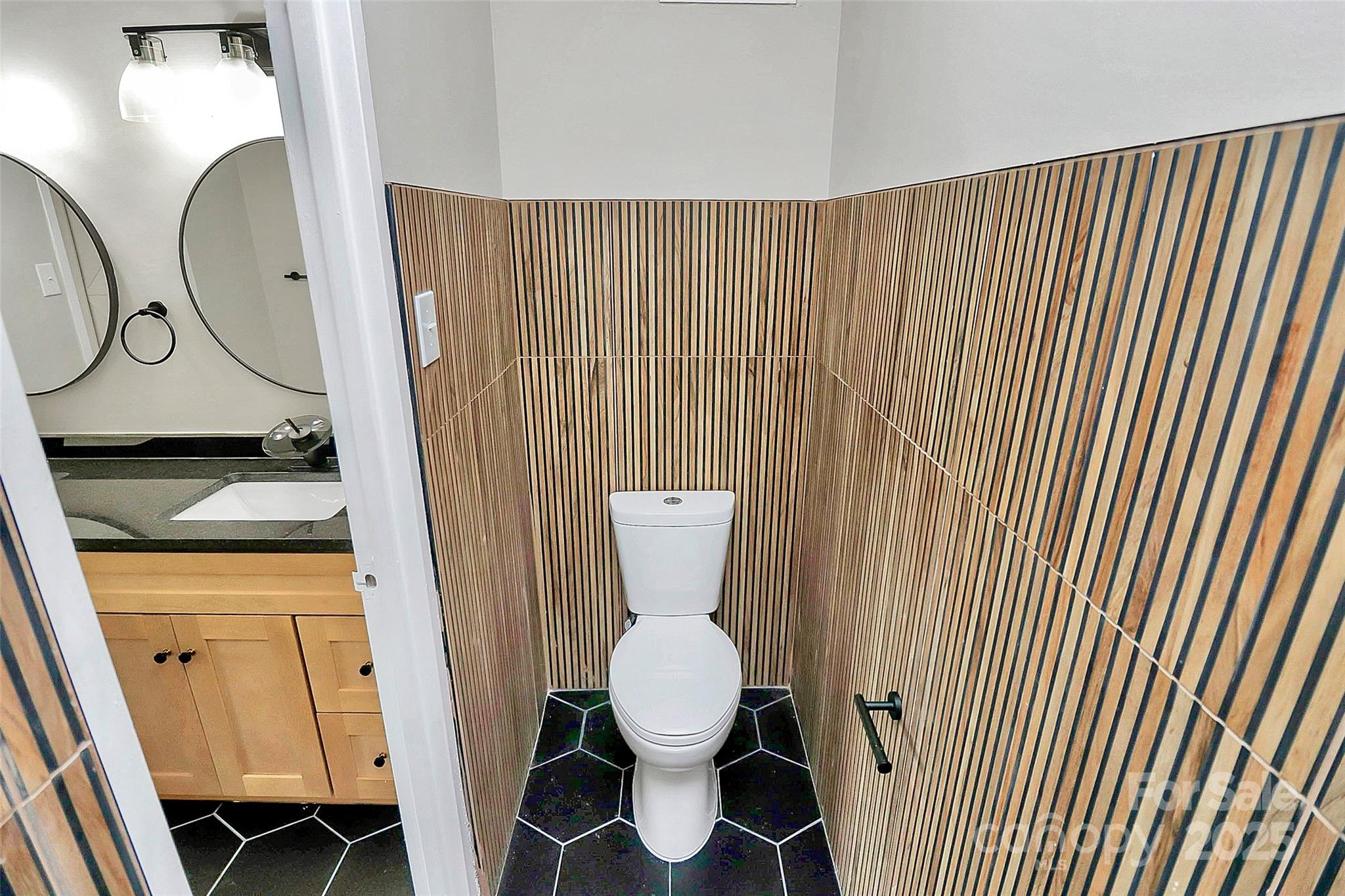 1300 Queens Road, Unit 409 Charlotte, NC 28207 - Photo 23 of 35 a bathroom with a toilet and a sink