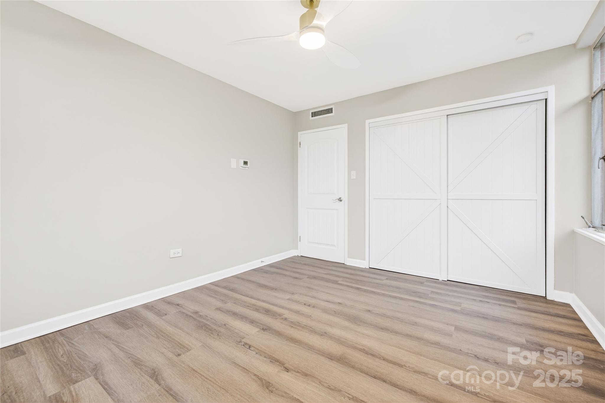 1300 Queens Road, Unit 409 Charlotte, NC 28207 - Photo 24 of 35 a view of empty room with wooden floor