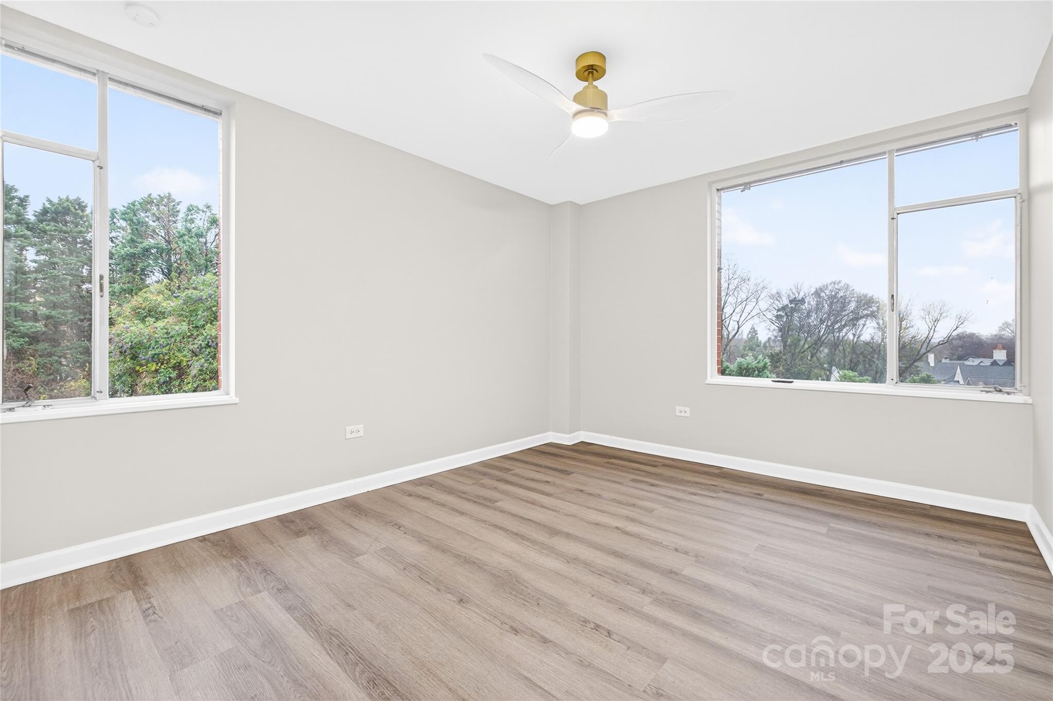 1300 Queens Road, Unit 409 Charlotte, NC 28207 - Photo 25 of 35 a view of an empty room with a window and wooden floor