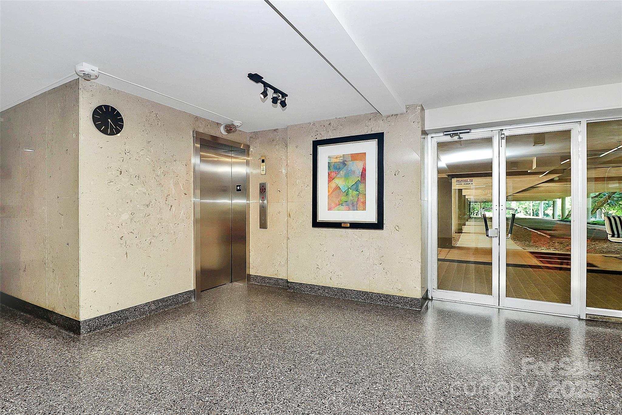 1300 Queens Road, Unit 409 Charlotte, NC 28207 - Photo 26 of 35 an empty room with windows and painted walls