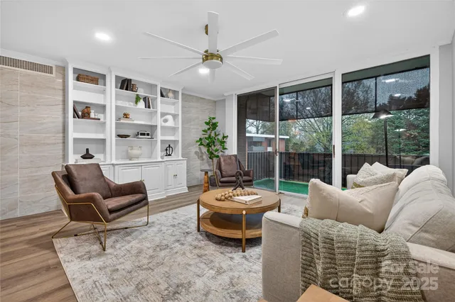 a living room with furniture and a floor to ceiling window