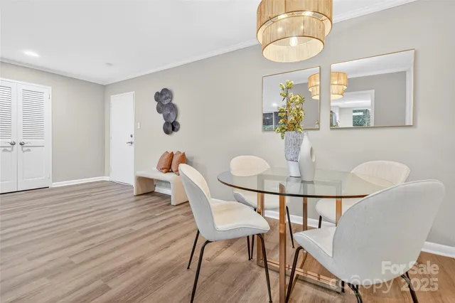 a dining room with furniture and wooden floor