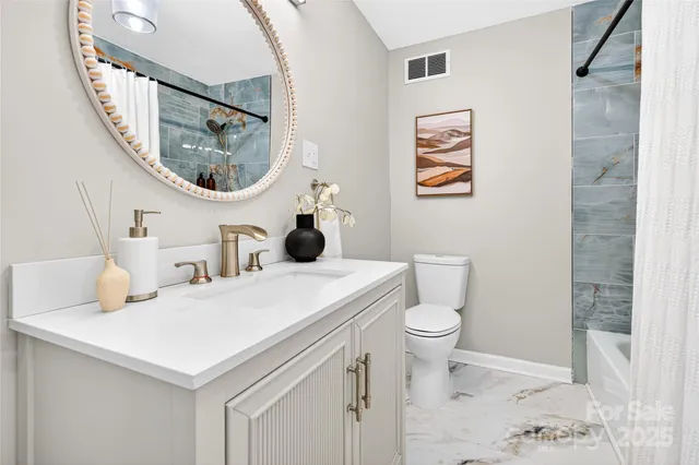 a bathroom with a toilet a sink and a mirror