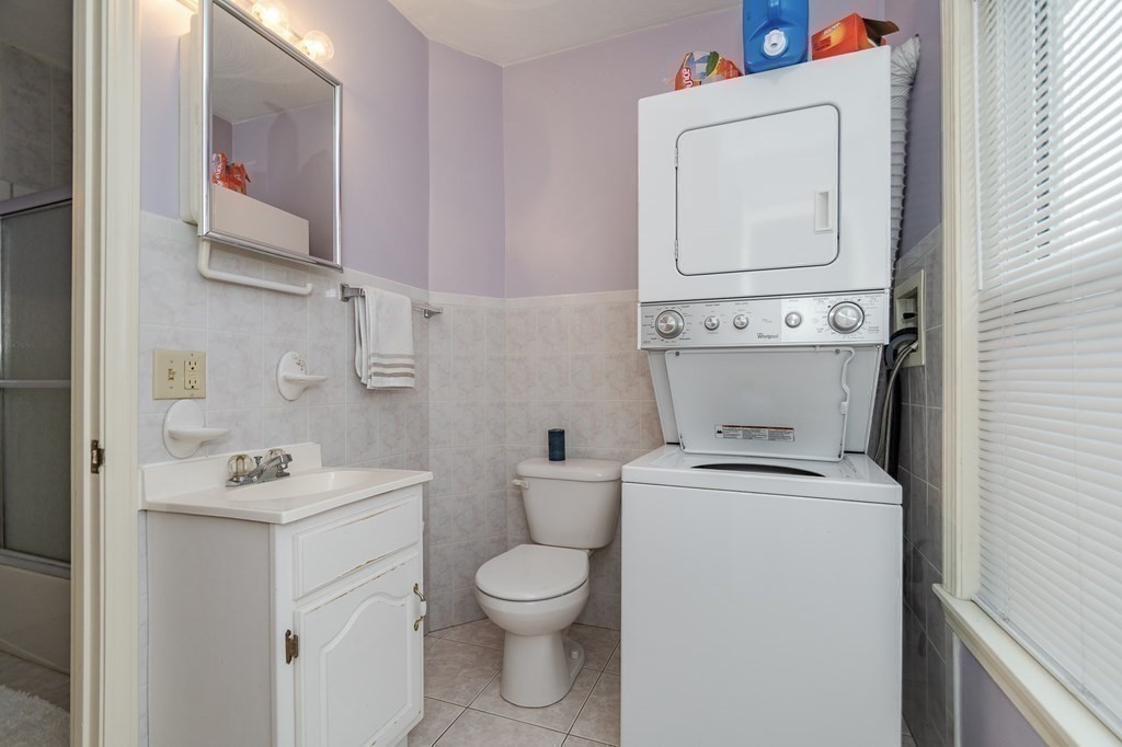 246 Haven Street, Unit 2 Reading, MA 01867 - Photo 14 of 23 a bathroom with a toilet sink and mirror