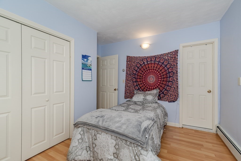 246 Haven Street, Unit 2 Reading, MA 01867 - Photo 15 of 23 a bedroom with a bed and a window