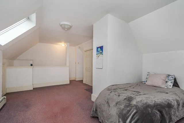 a bedroom with a bed and cabinets