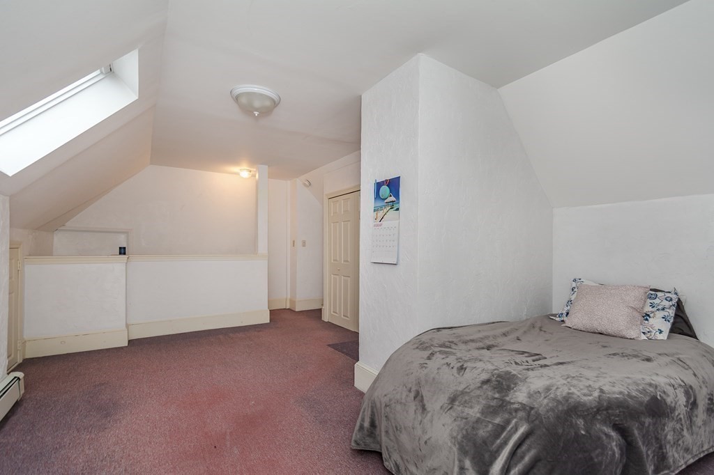 246 Haven Street, Unit 2 Reading, MA 01867 - Photo 18 of 23 a bedroom with a bed and cabinets