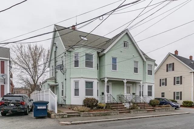 a front view of a house with a road