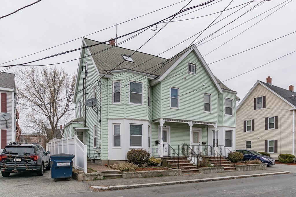 246 Haven Street, Unit 2 Reading, MA 01867 - Photo 2 of 23 a front view of a house with a road