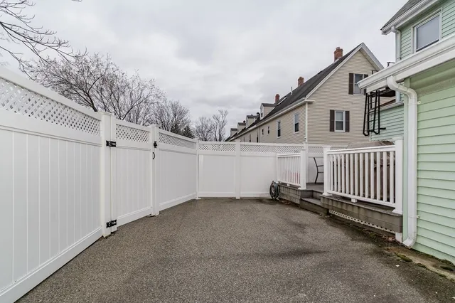 a view of a house with a wooden fence