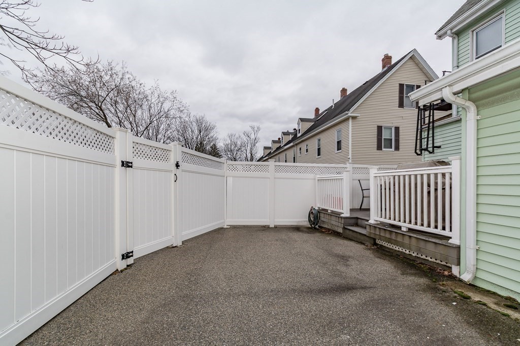 246 Haven Street, Unit 2 Reading, MA 01867 - Photo 22 of 23 a view of a house with a wooden fence
