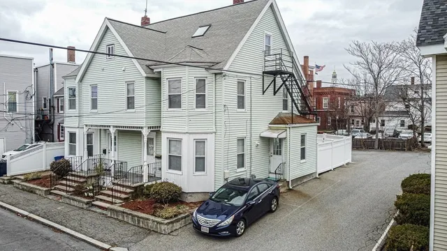 a car parked in front of a white building