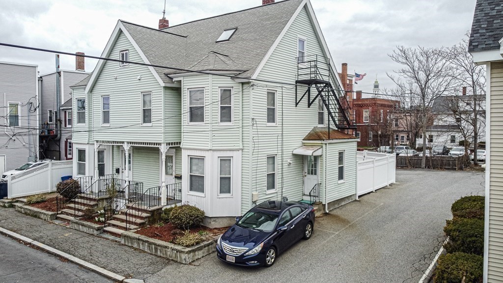 246 Haven Street, Unit 2 Reading, MA 01867 - Photo 3 of 23 a car parked in front of a white building
