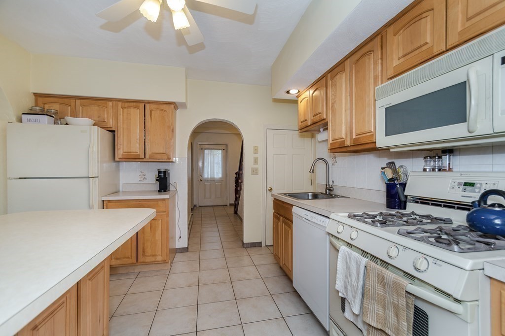 246 Haven Street, Unit 2 Reading, MA 01867 - Photo 10 of 23 a kitchen with a sink a stove and refrigerator