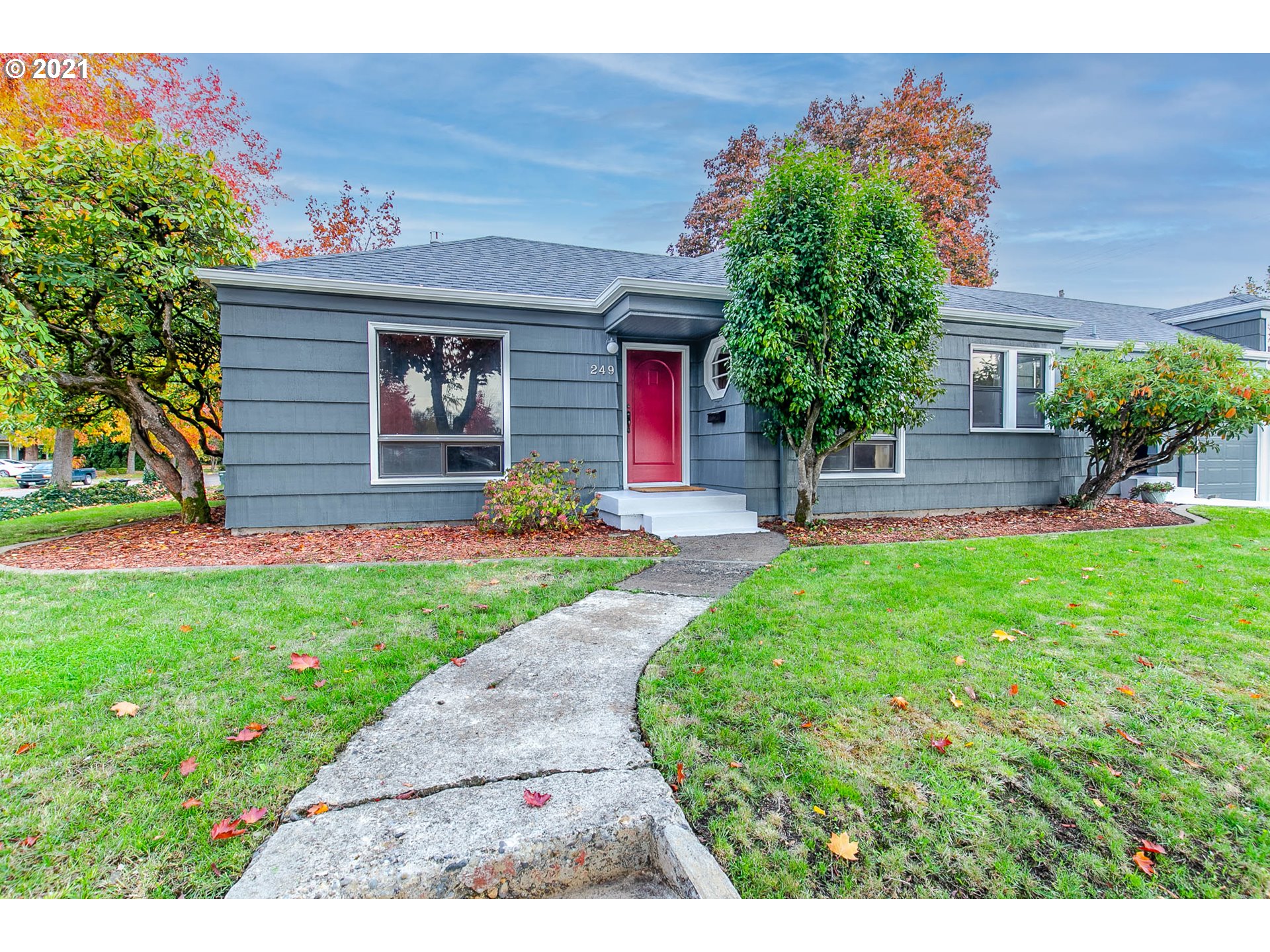 249 8th Street Springfield, OR 97477 - Photo 1 of 32 a front view of a house with a yard and potted plants