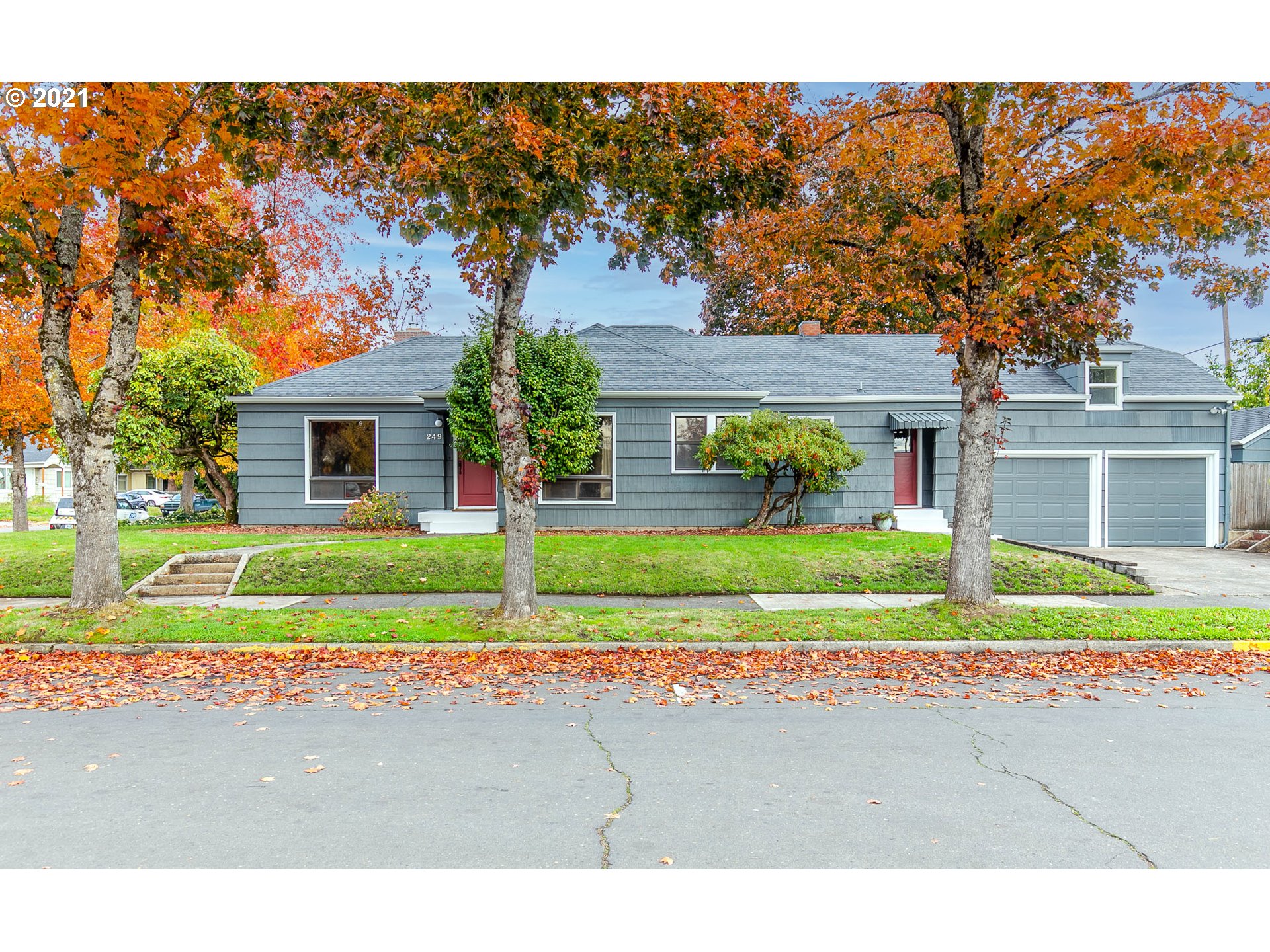 249 8th Street Springfield, OR 97477 - Photo 2 of 32 a view of a house with a yard and large tree