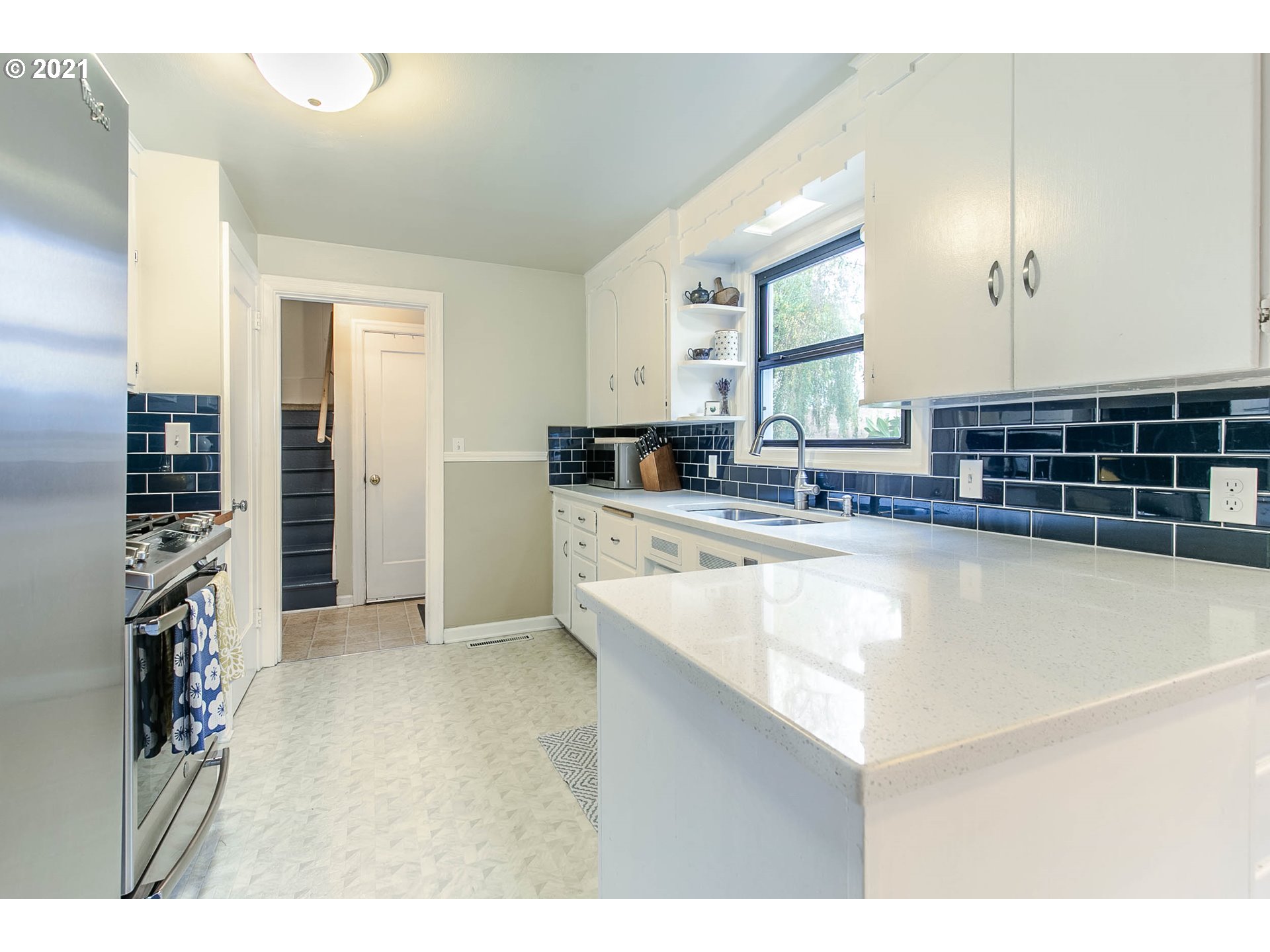 249 8th Street Springfield, OR 97477 - Photo 13 of 32 a kitchen with stainless steel appliances granite countertop a sink and cabinets