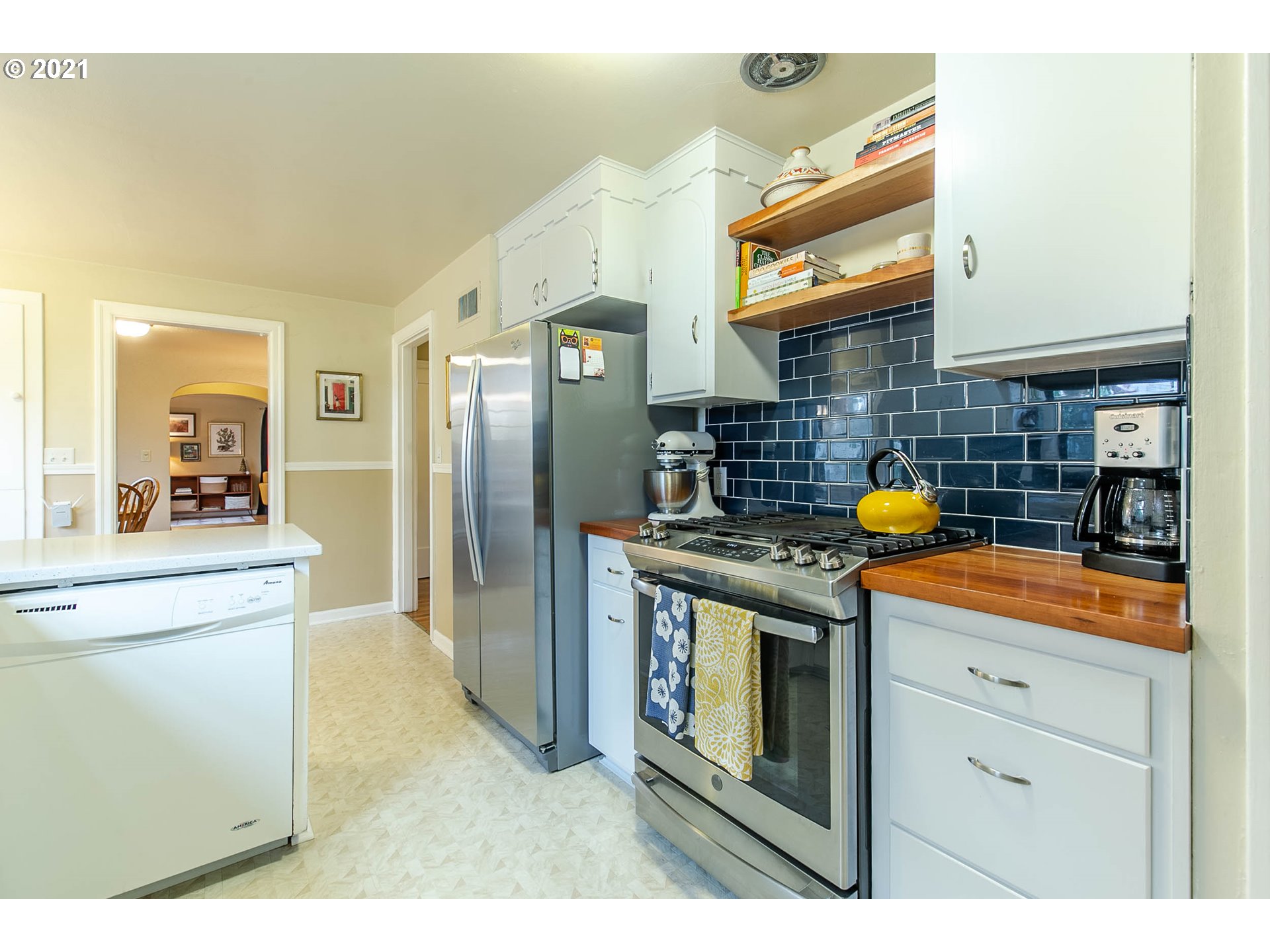 249 8th Street Springfield, OR 97477 - Photo 15 of 32 a kitchen with stainless steel appliances granite countertop a stove and a refrigerator