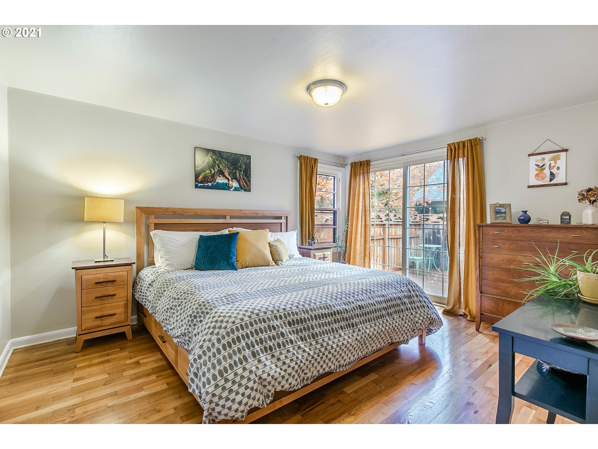249 8th Street Springfield, OR 97477 - Photo 22 of 32 a bedroom with a bed and a lamp on table