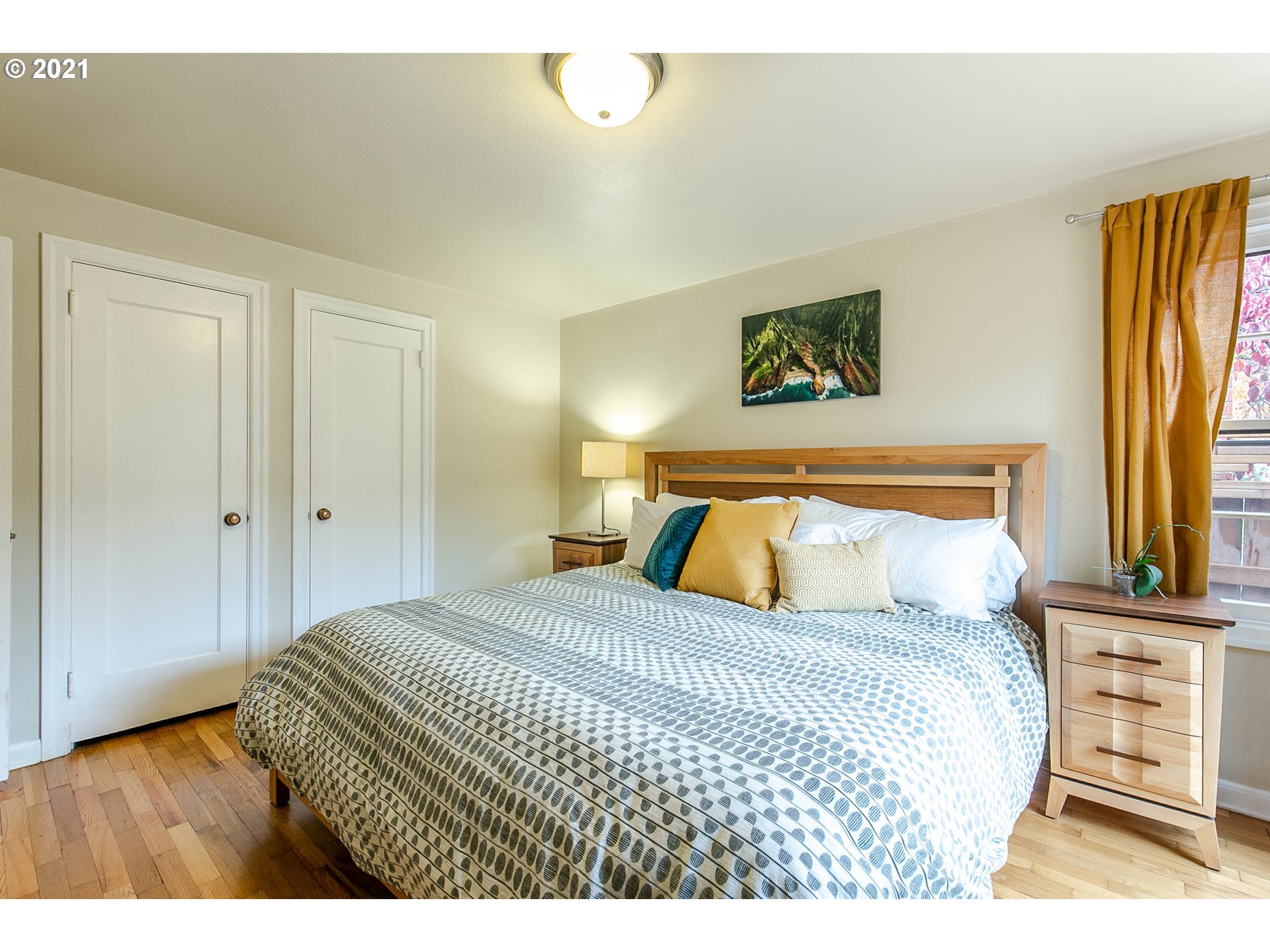 249 8th Street Springfield, OR 97477 - Photo 23 of 32 a bedroom with a bed and wooden floor