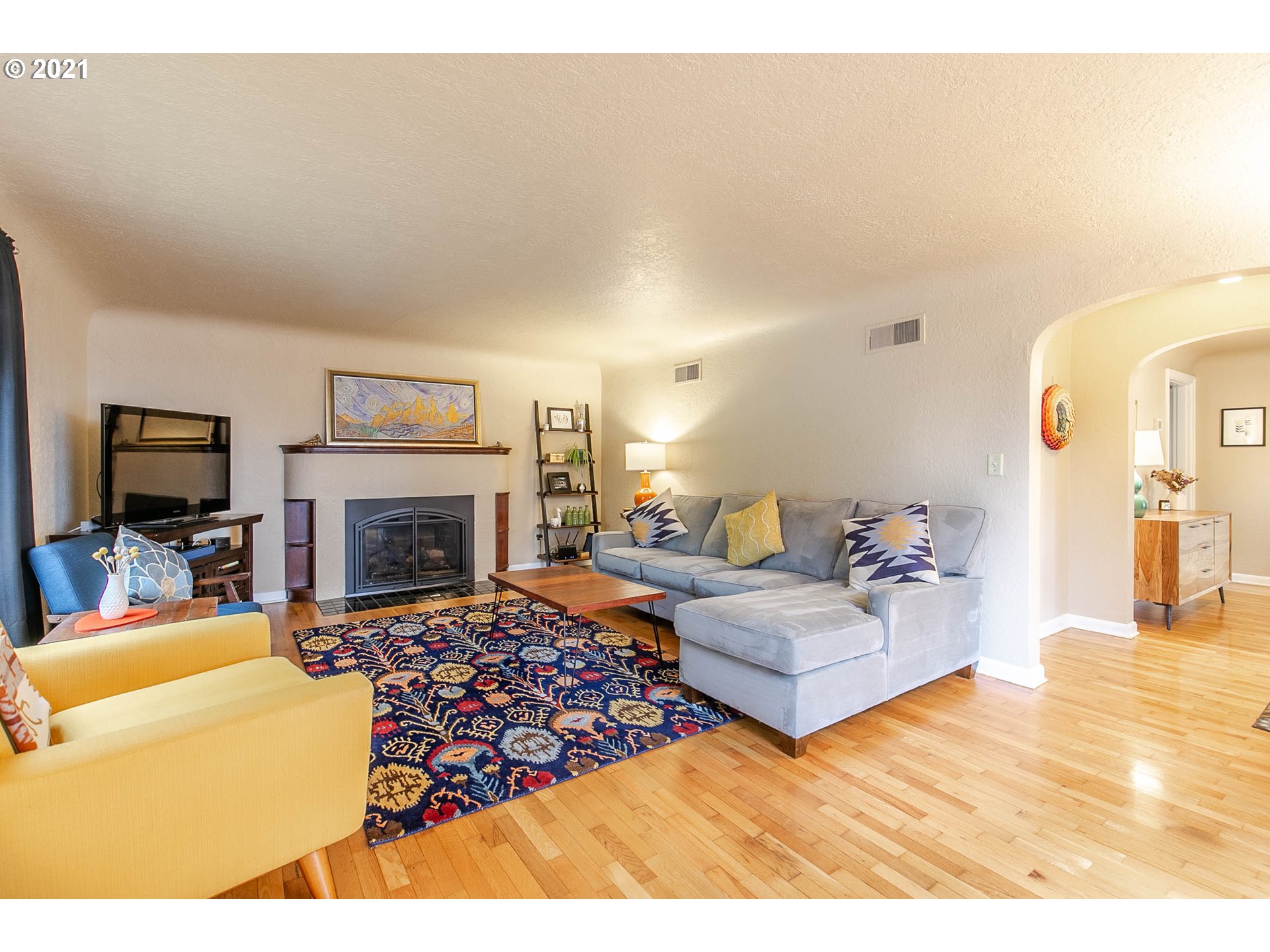 249 8th Street Springfield, OR 97477 - Photo 6 of 32 a living room with fireplace furniture and a flat screen tv