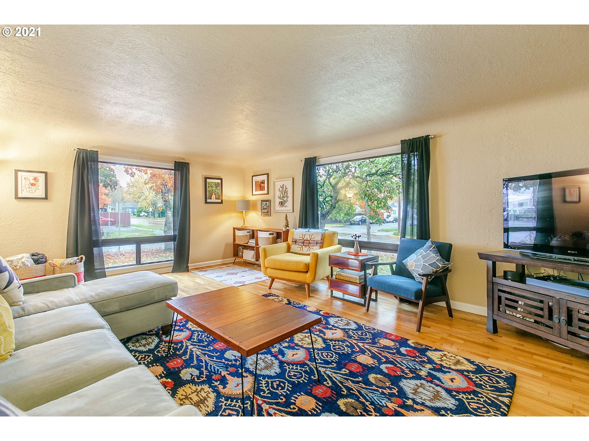 249 8th Street Springfield, OR 97477 - Photo 7 of 32 a living room with furniture a rug and a flat screen tv