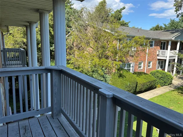 a view of a wooden fence and a yard