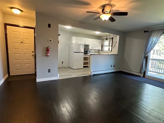 a view of a kitchen with wooden floor and a window