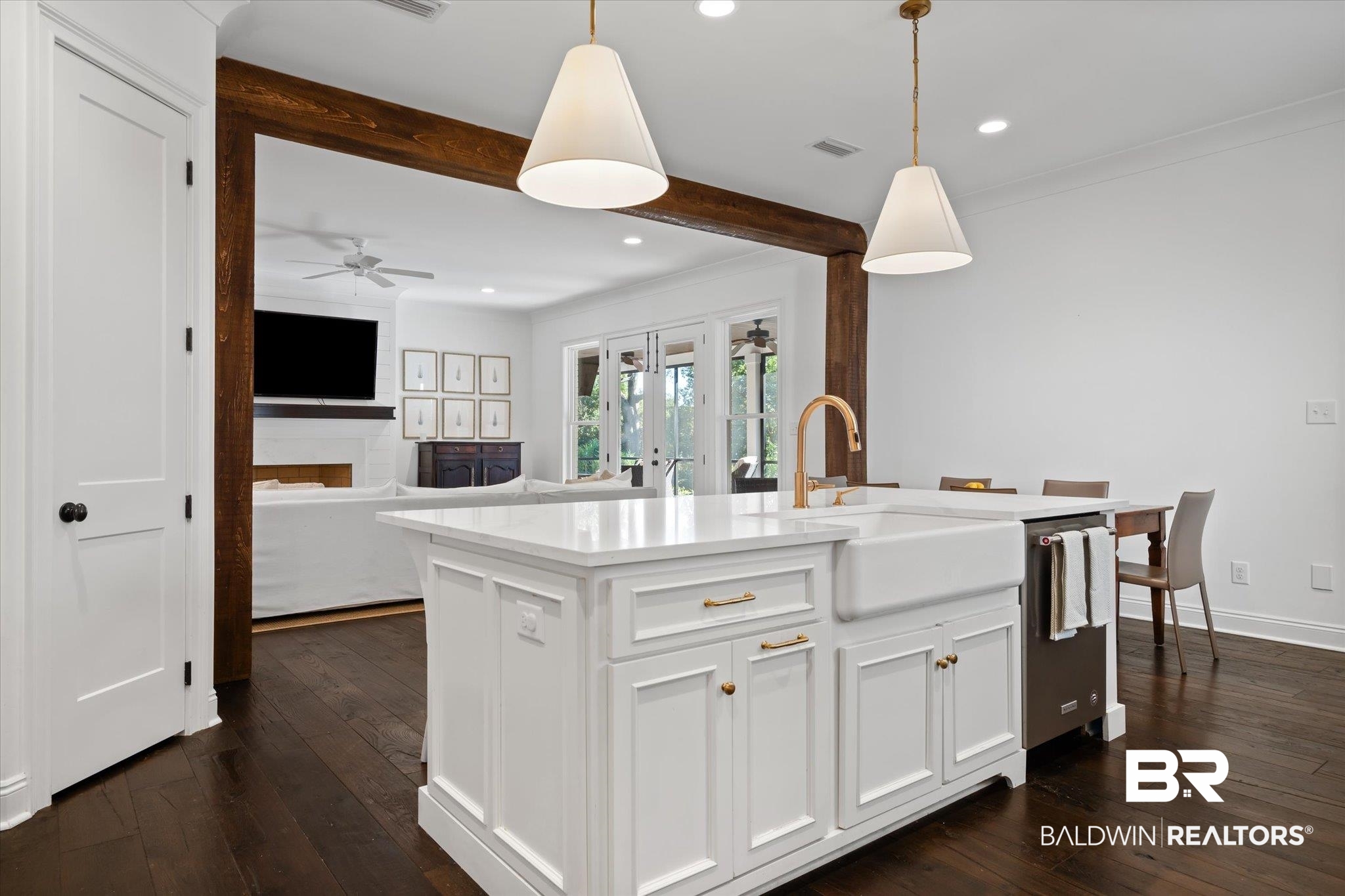 3713 Old Shell Road Mobile, AL 36608 - Photo 14 of 52 Kitchen featuring a kitchen island with sink, white cabinets, sink, hanging light fixtures, and stainless steel dishwasher