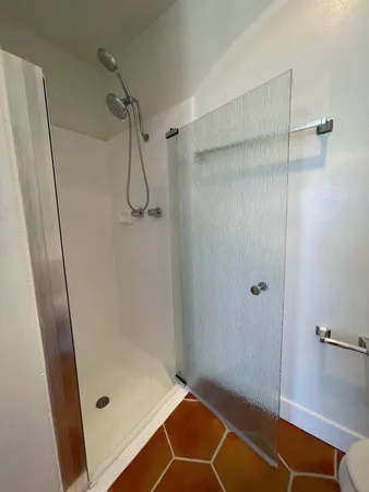 a bathroom with a glass shower door
