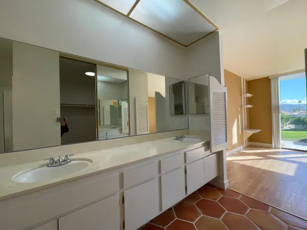 a bathroom with a granite countertop sink mirror and bathtub