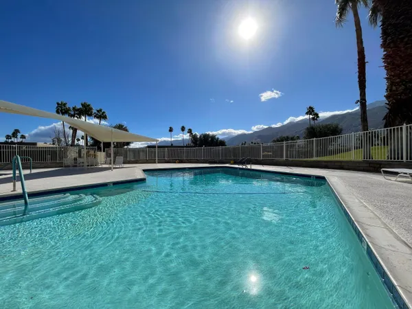 a view of a swimming pool and lounge chairs