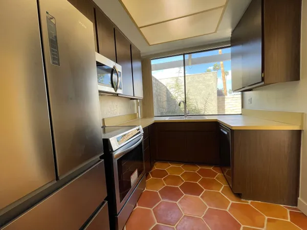 a kitchen with a refrigerator and window