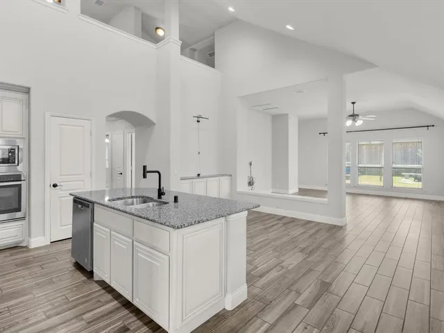 a kitchen with a sink and cabinets