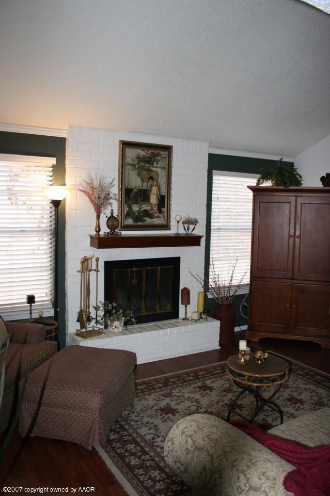 2702 Shadow Court Amarillo, TX 79110 - Photo 11 of 23 a living room with furniture a window and a fireplace