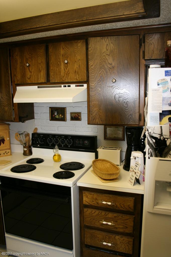 2702 Shadow Court Amarillo, TX 79110 - Photo 17 of 23 a kitchen with a sink cabinets and a wooden floor