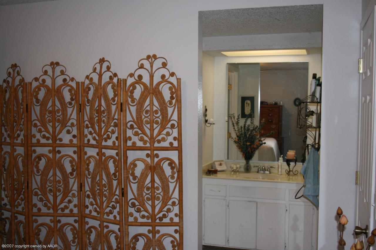 2702 Shadow Court Amarillo, TX 79110 - Photo 2 of 23 a bathroom with a granite countertop sink and a mirror