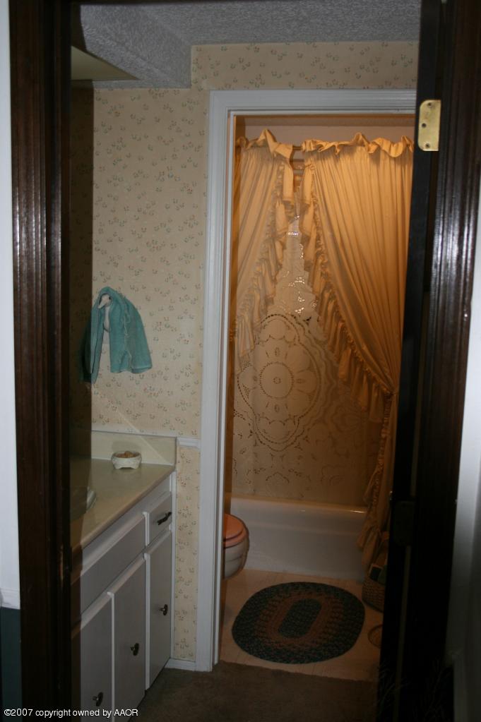 2702 Shadow Court Amarillo, TX 79110 - Photo 9 of 23 a bathroom with a sink and a shower curtain