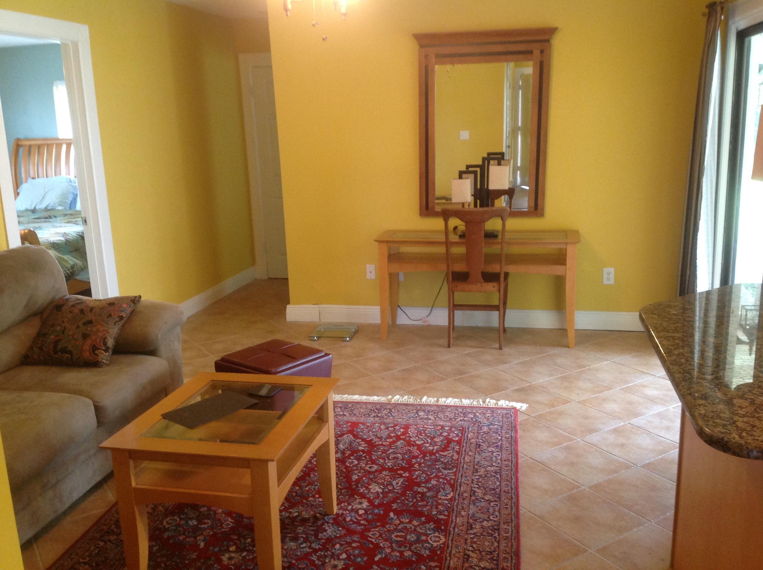 1545 Southeast Pitcher Road Port St. Lucie, FL 34952 - Photo 7 of 22 a living room with a couch and a dresser with wooden floor