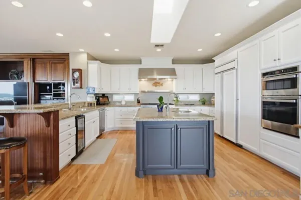 a kitchen with granite countertop cabinets stainless steel appliances and a sink