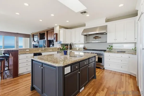a bathroom with a granite countertop sink a toilet and a mirror