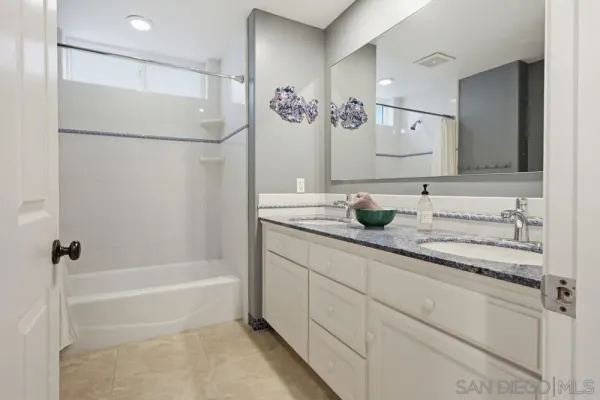 a spacious bedroom with a bed and a window