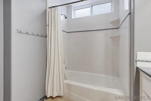 a view of walk in closet with clothes