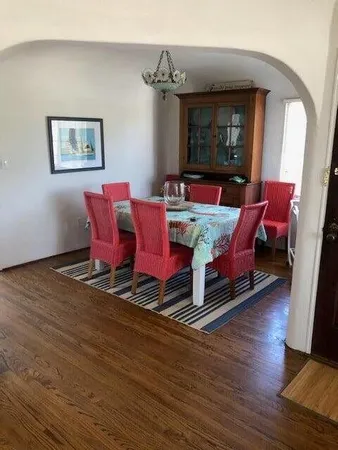 a living room with furniture rug and wooden floor