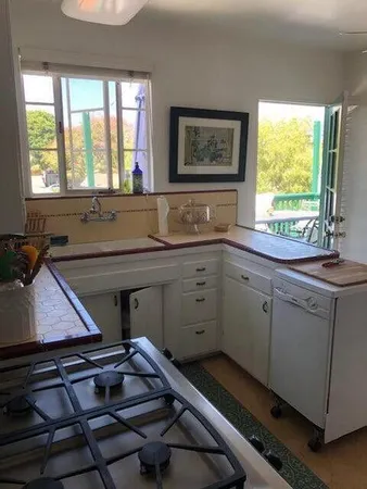 a kitchen with a sink stove and cabinets