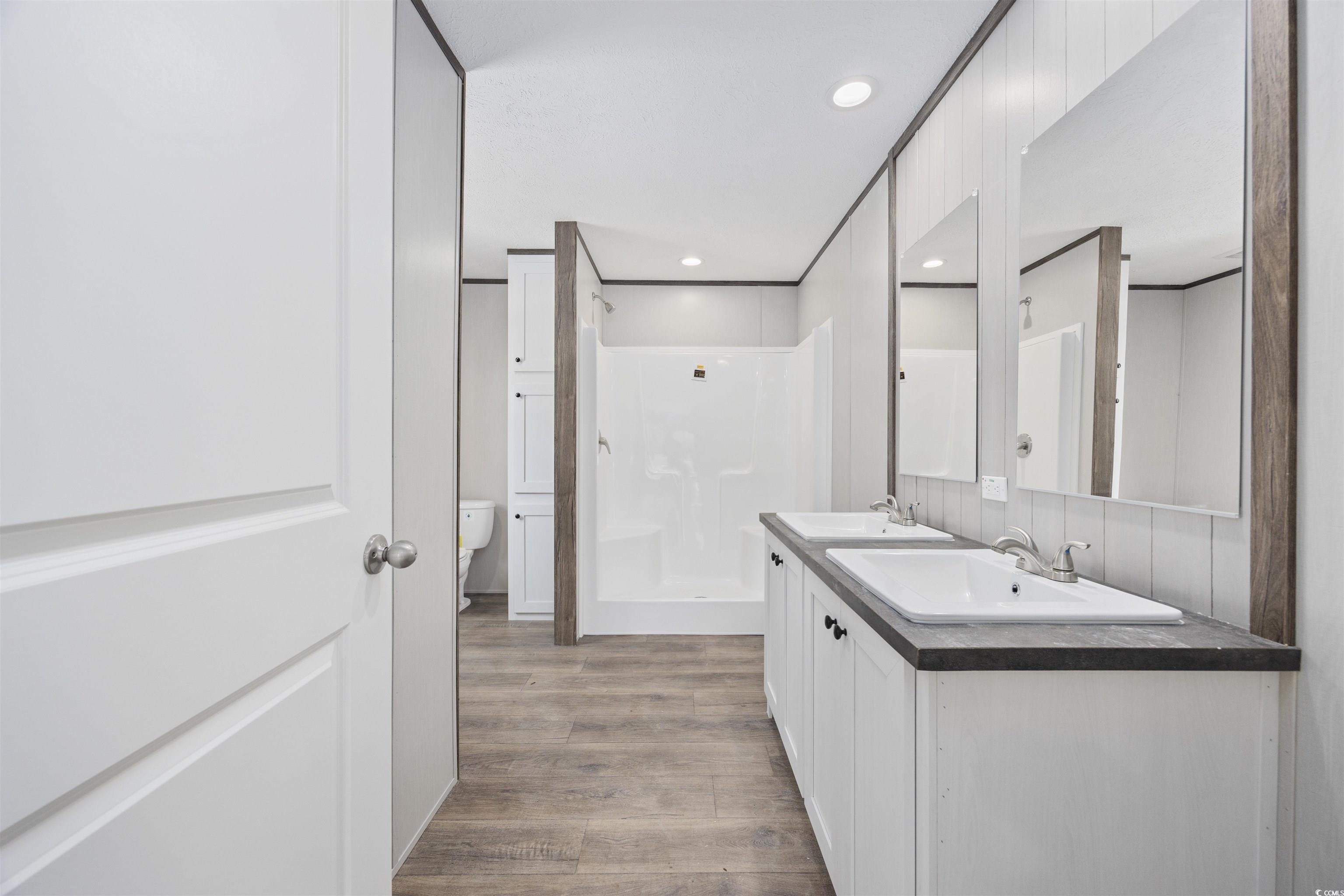 1315 Rabbit Lane Conway, SC 29526 - Photo 17 of 27 Bathroom featuring a shower stall, light wood-type flooring, double vanity, and recessed lighting